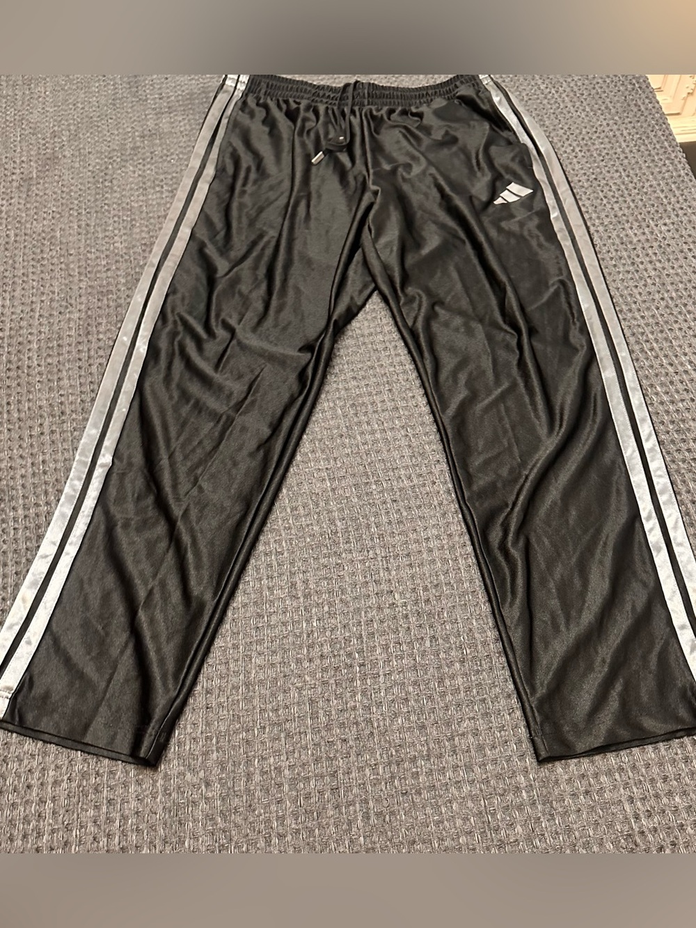 Adidas black track pants with gray accent stripes